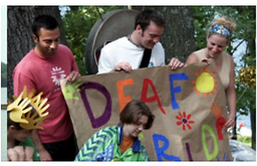 Historical Interlocken camp photo showing participants with a Deaf Pride banner